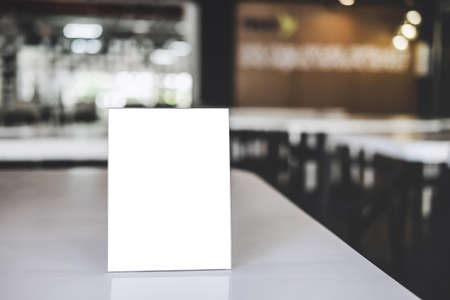 Mock up acrylic frame posters pattern template forms background, blank menu frame on table in coffee shop or restaurant stand for your text of display your product.の写真素材
