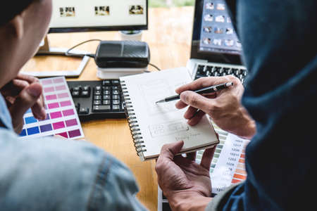 Young creative team having a meeting in creative office, Architectural drawing with work tools and accessories, Color swatch samples chart for selection coloring.の写真素材