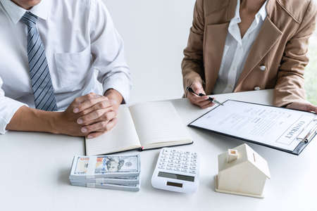 Real estate broker agent presenting and consult to customer to decision making sign insurance form...