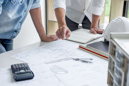 Architecture Engineer Teamwork Meeting, Drawing and working for architectural project and engineering tools on workplace, concept of work on technical drawings.の写真素材