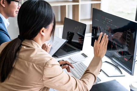 Business team investment working with computer, planning and analyzing graph stock market trading...