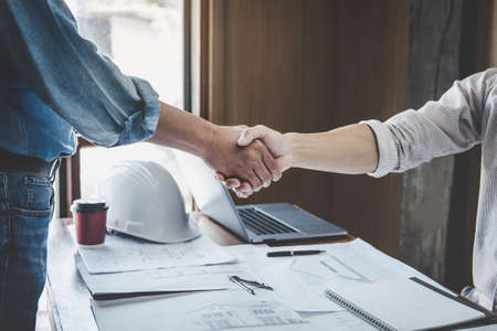 Meeting and greeting, Two engineer or architect meeting for project, handshake after consultation and conference new project plan, contract for both companies, success, partnership.の写真素材