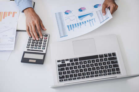 Professional at work, business woman working and analyzing on laptop with calculate statistics of...