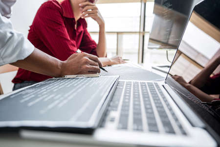 Two professional programmer cooperating and working on web site project in a software developing on...