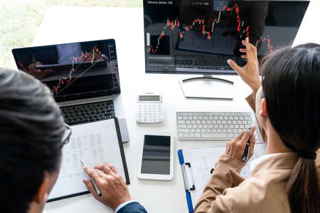 Business team partner working with computer, laptop, discussion and analyzing graph stock market...