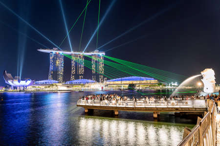 Singapore, Singapore - Aug 4, 2019 : Singapore skyline of marina bay Beautiful laser show at Marina Bay Sands Hotel in night time, popular for tourist and landmark center with cost of US$ 4.7 billion.のeditorial素材