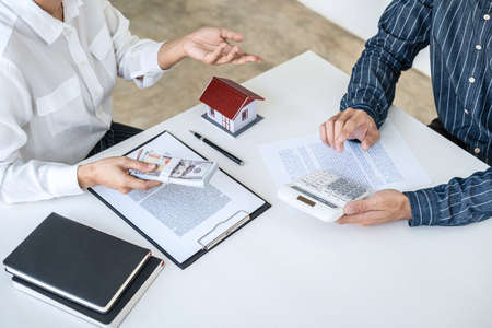 Real estate broker agent being analysis and making the decision a home estate loan to customer,...