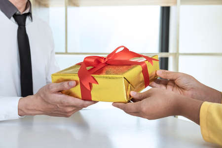 Couple giving gift box to each other with birthday greeting or celebration day and christmas.