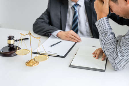 Male lawyer or Counselor working in courtroom have meeting with client are consultation with contract papers of real estate, Law and Legal services concept.の写真素材