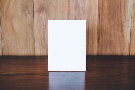 Mock up acrylic frame posters pattern template forms background, blank menu frame on table in coffee shop stand for your text of display your product.の写真素材