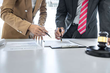 Businesswoman and Male lawyer or judge consult having team meeting with client, Law and Legal services concept.の写真素材