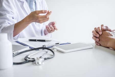 Doctor presenting report of diagnosis, symptom of disease and recommend something a method with patient treatment, after results about the problem illness of patient.の写真素材