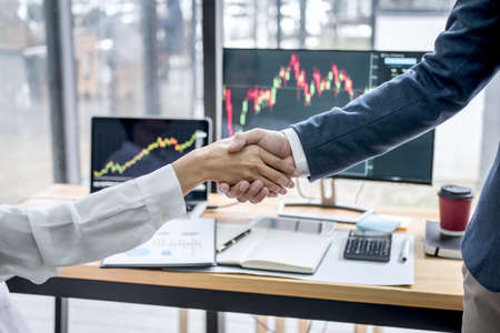 Business handshake after discussion and analyzing graph stock market trading good deal of Trading to sign agreement and become a business partner, contract for both company.の写真素材