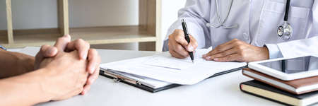 Doctor presenting report of diagnosis, symptom of disease and recommend something a method with patient treatment, after results about the problem illness of patient.の写真素材