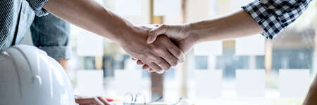 Finishing up a meeting, Two engineer or architect meeting for project, handshake after consultation and conference new project plan, contract for both companies, success, partnership.の写真素材
