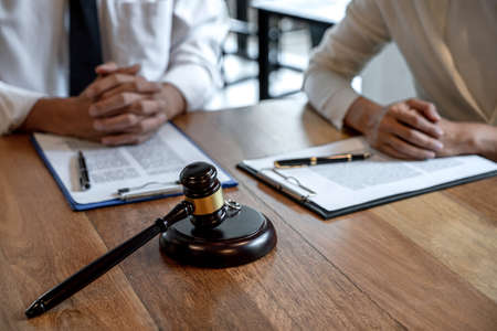 Judge gavel and two golden marriage ring, Contract decree of divorce (dissolution or cancellation)...