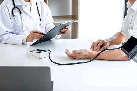 Doctor being measuring examination patient and checking blood pressure to symptom diagnosis illness...