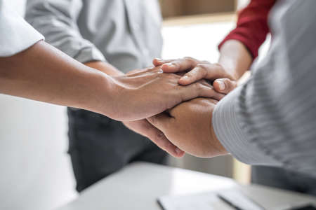 Image of business people joining and putting hands together during their meeting, connection and collaboration concept, Teamwork process of partner and best relationship.の写真素材