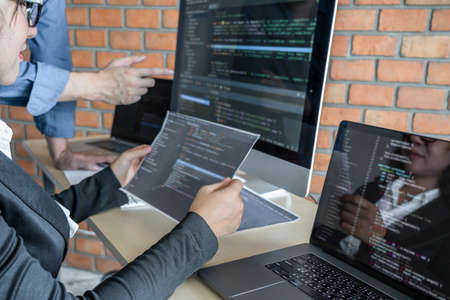 Two professional programmer cooperating and working on web site project in a software developing on...