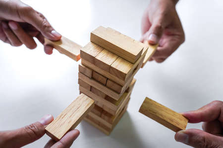 Plan and strategy in business, Risk To Make Business Growth Concept With Wooden Blocks, hand of man...