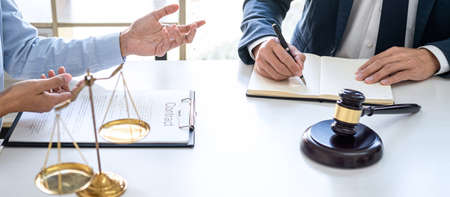 Businesswoman and Male lawyer or judge consult and conference having team meeting with client at law...