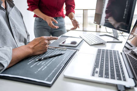 Programmers cooperating at Developing programming and website working in a software develop company...