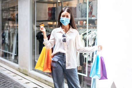 Portrait of Asian girl excited beautiful girl wearing protective mask happy smiling with holding...