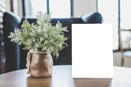 Mock up acrylic frame posters pattern template forms background, blank menu frame on table in coffee shop stand for your text of display your product.の写真素材