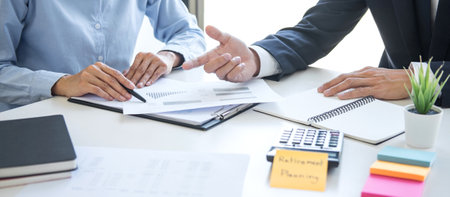 Business team executive accounting analyzing and calculation on valuation data investment fund looking at report, sticky note paper and having a consultation, Wealth Management and investment concept.の写真素材
