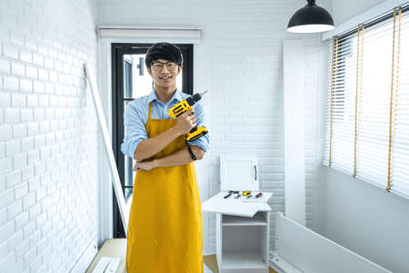 Portrait of Craftsman doing renovation work at home improvement with holding drill and interior design concept.の写真素材