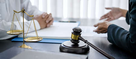 Female lawyer and businessman discussion about terms, condition and legal document agreement for...