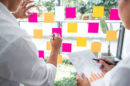 Business team working marketing growth on financial document graph report statistics, using post it...