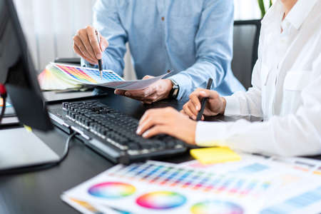 Team graphic designer working on document of color chart to brainstorming about new project and...