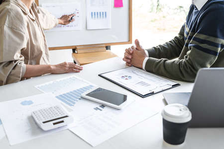 Business casual manager presenting and discussing company growth project success financial...