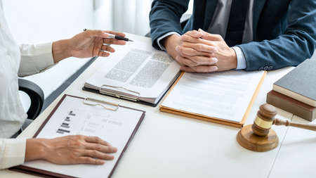 Male lawyer and professional businesswoman working and discussion having at law firm in office,...