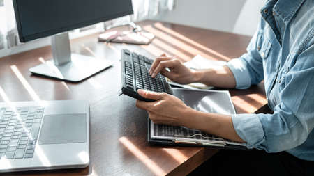 Close up of hand asian woman programmer typing code data about new project with keyboard on laptop...