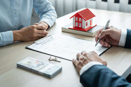 Real estate broker agent consulting the customer to a decision making sign insurance form contract,...