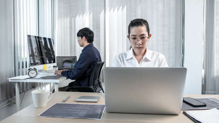 Team of two professional programmers working on website projects in software development and making coding and typing data code password security in office.の写真素材