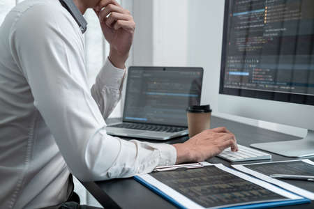 Professional programmer working on website project in software development on the desktop computer,...