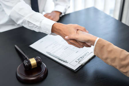 Businesswoman shaking hands with Professional male lawyer after discussing a good deal of contract...
