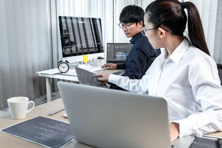 Team of two professional programmers working on website projects in software development on the...