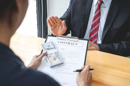 Businessman is refuses don't receive to accept banknote money and terms of contract from corruption...
