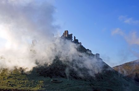 Ruins of Corfe Castle, in Swanage, Dorset, Southern England as seen from the steam train running alongside.の写真素材
