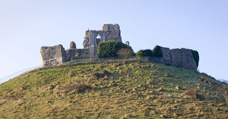 Ruins of Corfe Castle, in Swanage, Dorset, Southern England as seen from the steam train running alongside.の写真素材