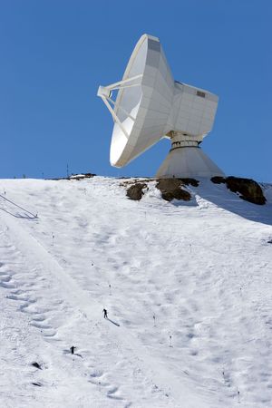 Snowy ski slopes of Prodollano ski resort in the Sierra Nevada mountains in Spain with large telescope and observatoryの写真素材