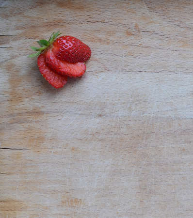 Sliced strawberries on wooden background concept for healthy foodの写真素材