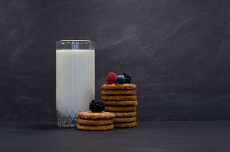 ereal cookies biscuit with a glass of milk isolated on black backgroundの写真素材
