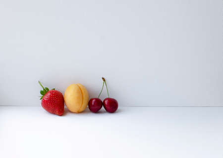 Ripe tasty berries apricot, sweet cherry, strawberry on white backgroundの写真素材
