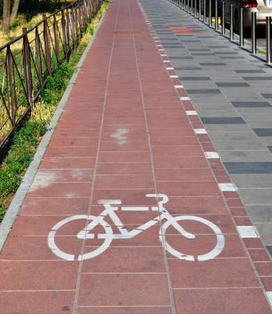 Separate bicycle lane on asphalt in the park. White bike symbolの写真素材