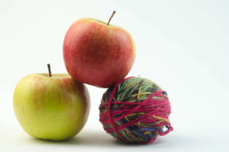 apples on a tangle of yarnの写真素材